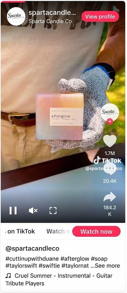Image 4: TikTok video from Sparta Candle Co. showing a gloved hand holding a multi-colored soap named Afterglow 