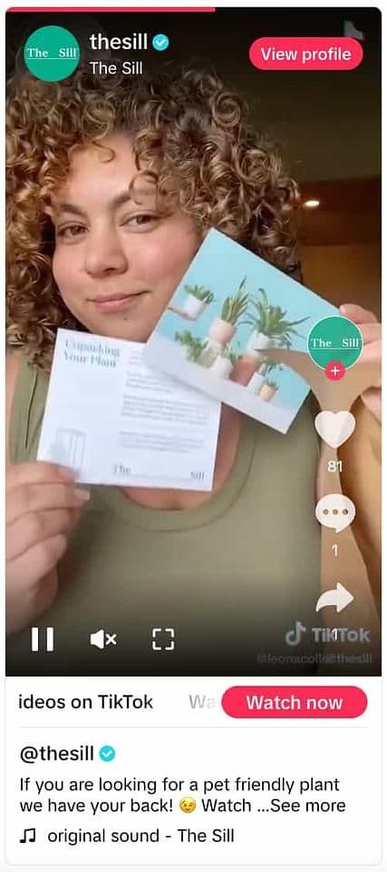Image 12: TikTok video from The Sill showing a person holding up two marketing inserts from the brand