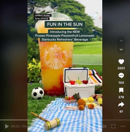Image 22: A Starbucks video on TikTok featuring a new drink. The drink is shown within a miniature picnic set.